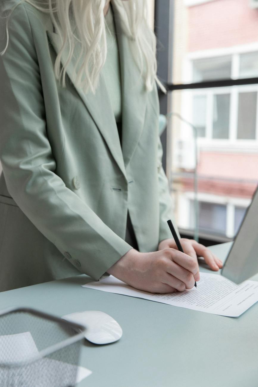 crop businesswoman working with documents in office